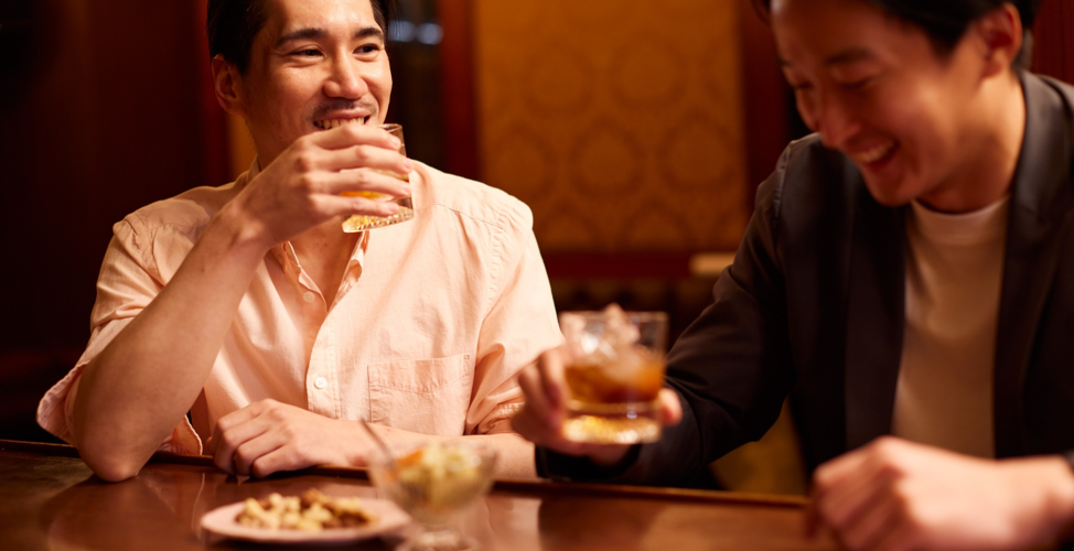 Brothers Sharing A Drink And Meal